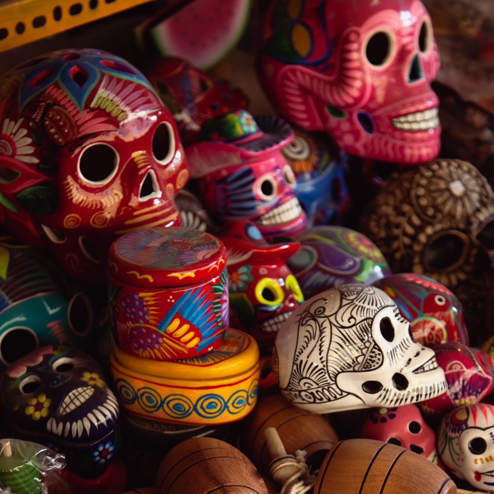 Vibrant Mexican skulls and traditional toys on display, perfect for cultural themes.